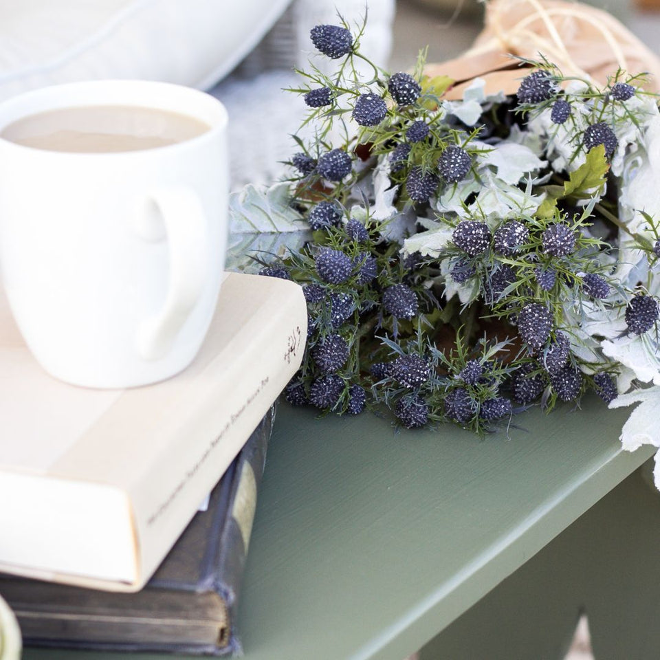 Smooth bench in Fusion Mineral Paint in the colour Bayberry with coffee on books with lavender flowers